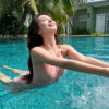 Neck-hugging swimsuit with gathered waist to show a slim silhouette