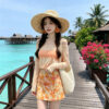 Long-sleeved and short-skirt split-body swimsuit for the beach